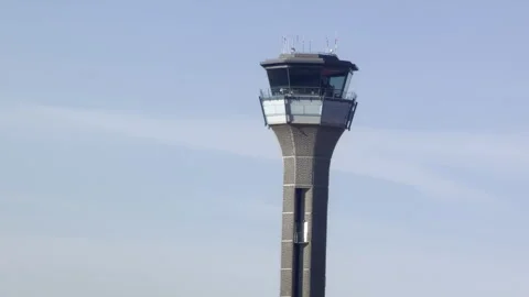 Air traffic control tower against blue sky Vídeos de archivo 333644653