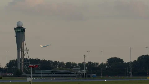 Air traffic control tower with airplane taking off in background Stock Footage 288701705
