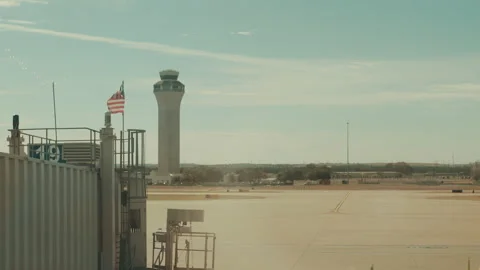 Air traffic control tower and American flag at airport Stock Footage 347828388