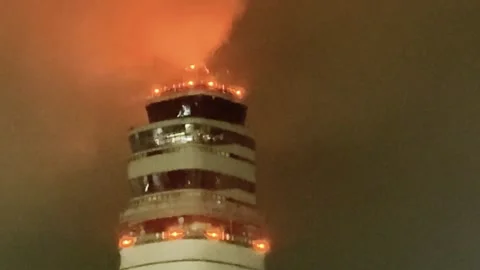 Air Traffic Control Tower Engulfed in Thick Smoke and Fire at Night Stock Footage 331225063