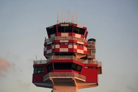 Air Traffic Control Tower Red Checkered Pattern at Sunset Stockfoto's