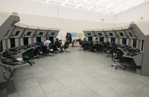 Air Traffic Controllers in air traffic control center with monitors and radar Stock Photos