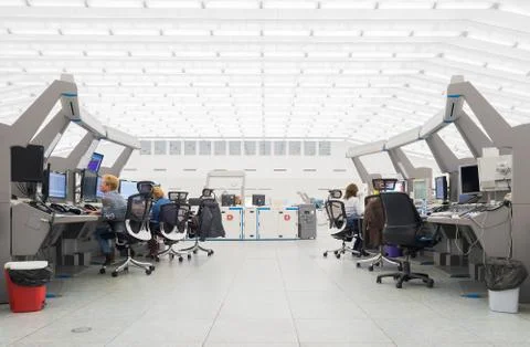 Air Traffic Controllers in air traffic control center with monitors and radar Stock Photos
