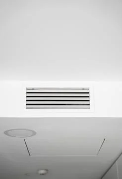Air ventilation grille on white ceiling in modern interior Stock Photos