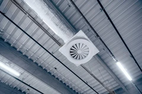 Air ventilation system on the ceiling in a large warehouse Foto stock
