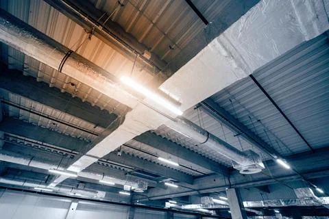 Air ventilation system on the ceiling in a large warehouse Stock Photos