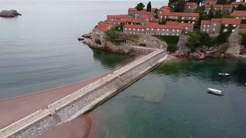 Air view of long stone bridge leading to the island washed by the sea Stock Footage 167686327