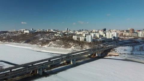 Air view of the road bridge with heavy traffic, in winter, on bright sunny day. Stock Footage 129884059