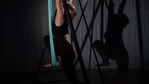 An air yoga coach climbs into a hammock Stock Footage