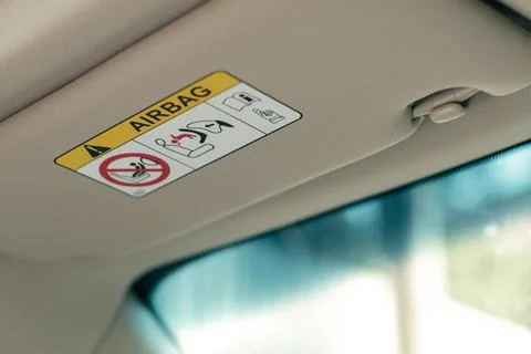 Airbag warning label on sun visor Stock Photos