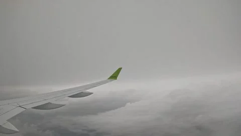 AirBaltic airplane cruising between thick overcast cloud layers Stock Footage 340320566