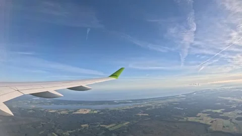 AirBaltic airplane flying high over coastline and sea on a sunny day Stock-Footage 340320558