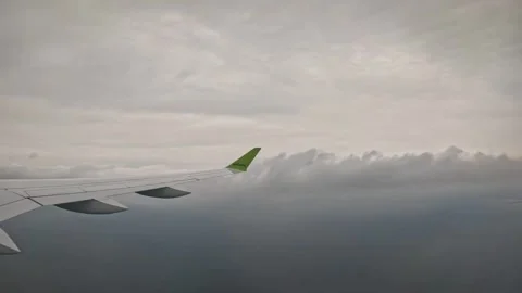 AirBaltic airplane flying low over dark open ocean under overcast sky Stock Footage 340320571