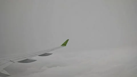 AirBaltic airplane flying through thick overcast clouds and grey fog Stock Footage 340320564