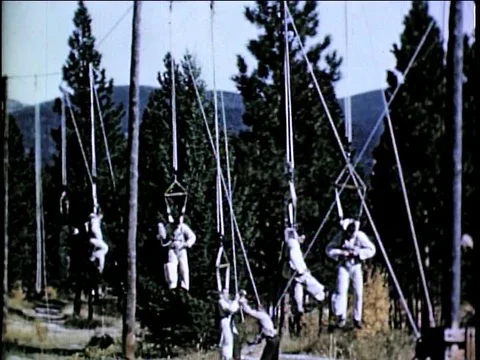 Airborne firefighters practice let down rope procedures for parachute landing Stock Footage 75416518