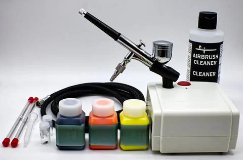 Airbrush kit set with mini compressor and tools isolated on white Stock Photos