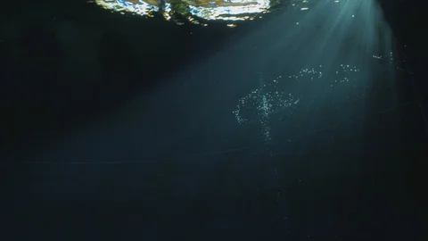 Airbubbles and Sunrays in swimming pool, under water shot Stock Footage 95596596