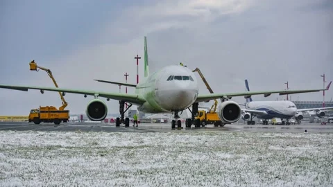 Airbus A330-343 is getting de-iced on the airport of linz Stock Footage 150718885