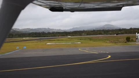 Airbus A330 moving down runway through Cessna window Stock-Footage 76561041