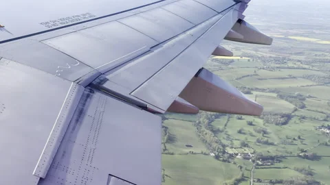 Aircraft arriving over patchwork meadows panning Vídeos de archivo 333648623