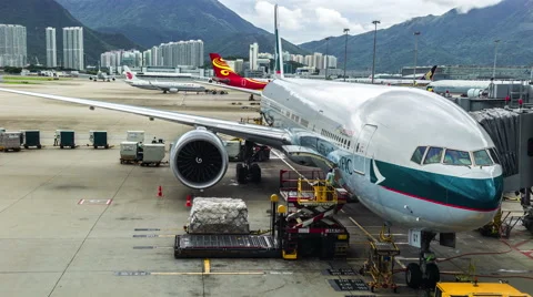 Aircraft Cathay Pacific is preparing to load luggage in Hong Kong Airport Stock Footage