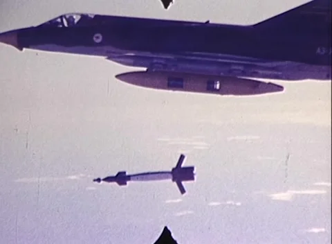 AIRCRAFT DROPS BOMB WITH EXPLOSION (1970s) Stock Footage 252107410