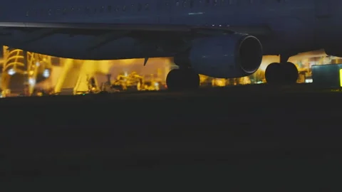 Aircraft engine and fuselage close up at night on airport apron Stock-Footage 334345027
