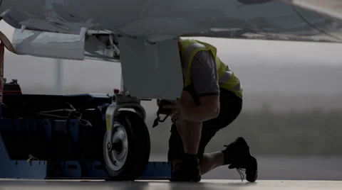 Aircraft engineer working on Private Jet landing gear Stock Footage 55692499
