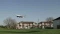 Aircraft flies low over houses HD Footage