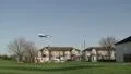 Aircraft flies low over houses HD Footage