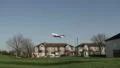 Aircraft flies low over houses HD Footage