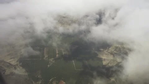 The aircraft flies over the clouds floating high above the ground. Stock Footage 142087586