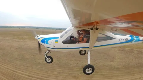 Aircraft in flight, showcasing a dynamic aerial view of the landscape below Stock Footage 324800888