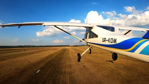 Aircraft in flight, showcasing the wing and landing gear, gliding smoothly over Video stock 328159698