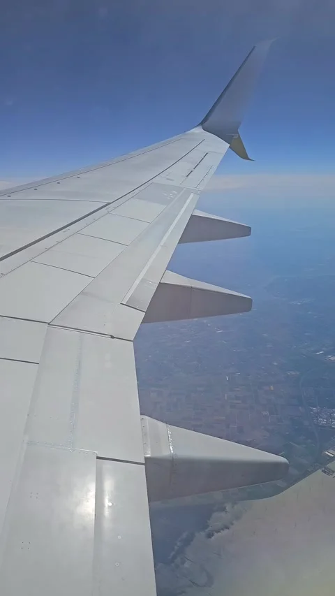 Aircraft flying above patchwork farmland near river delta. Jet cruising over 스톡 동영상 329066697