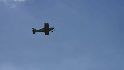 Aircraft Flying Against Dramatic Textured Cloudscape Slow Motion 4K Stock Footage 345059661