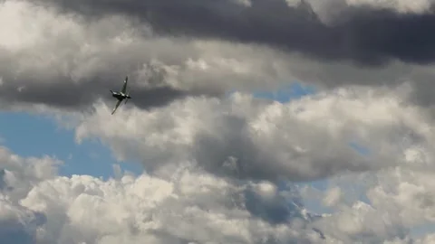 Aircraft Flying Against Dramatic Textured Cloudscape Slow Motion 4K Stock Footage 345063183