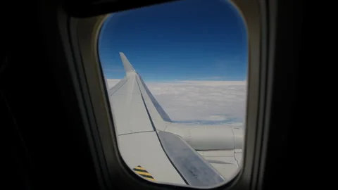Aircraft flying in clouds airplane Wing and blue sky. Wide footage Stock Footage 258594822