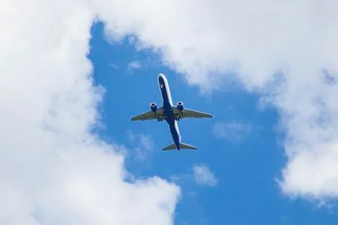 Aircraft flying with clouds in background Foto stock