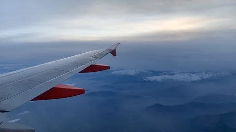 Aircraft flying high over clouds and mountains. Concept for traveling by plane 스톡 동영상 123919623