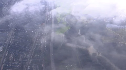 Aircraft flying through a cloud with a cityscape of London below Stock Footage 142709270