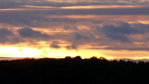 Aircraft flying through clouds moving over forest near sunset in autumn Video stock 143608082