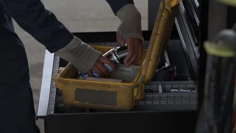 Aircraft ground crew checking condition of aerosol spray cans  Stock Footage 98028894