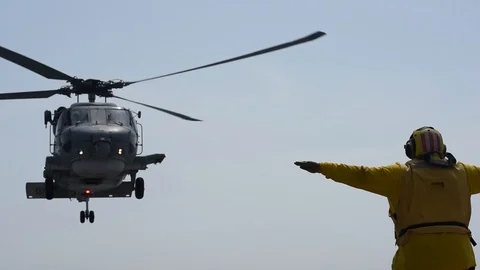 Aircraft handler directing Turkish S-70B Seahawk pilots aboard USS Mount Whitney Stock Footage 110843930