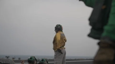 Aircraft handler signals aboard USS John C Stennis Stock Footage 101373888