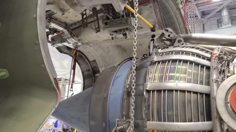 Aircraft jet engine being wheeled into position under pylon. Stock Footage 171463201