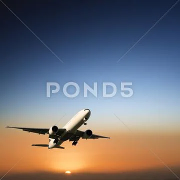 Aircraft landing at sunset Stock Photos