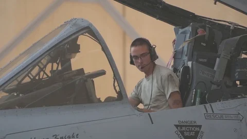 Aircraft maintainer testing controls in cockpit of A-10 Thunderbolt II Stock Footage 105715782