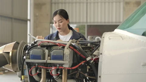 Aircraft maintenance engineer doing a checkup or maintenance in hangar. Video stock 141988108
