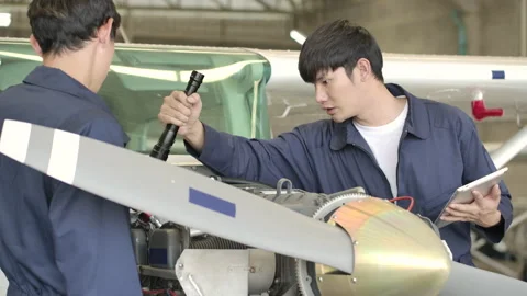 Aircraft maintenance engineer doing a checkup or maintenance in hangar. Stock Footage 141989325